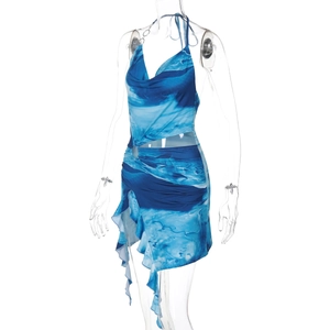 Detail of blue wave print dress with side cutout, metal ring and ruffled hemline