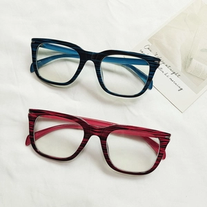 Retro square anti-blue light glasses with blue and red striped texture on white fabric