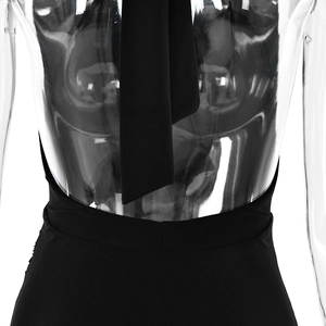 Detail of black halter neck and open back design on a long dress with slit