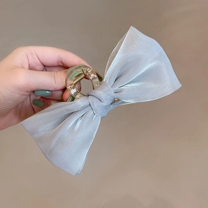 Detail of light blue mesh fabric bow hair claw clip with beads for French hairstyle