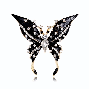 Detailed view of luxury black enamel butterfly brooch with crystals and gold metal finish