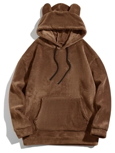 Detail of warm brown teddy fleece hoodie featuring cute bear ears and plush texture