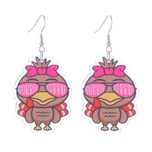 Detailed macro view of acrylic Thanksgiving turkey earrings with Gobble Gobble text