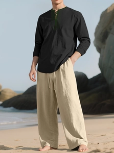 Men's linen set featuring a black shirt with green embroidery and beige beach trousers