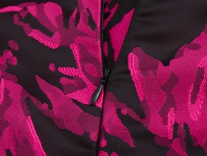Detail of pink and black jacquard fabric with a concealed zipper on the vintage dress