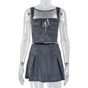Detail view of black striped two-piece set featuring lace-up crop top and mini skirt