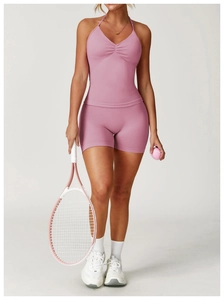 Detail of dry rose seamless yoga set featuring V-neck ruched halter top and gym shorts
