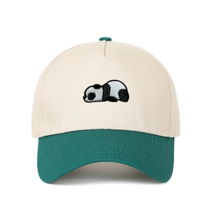 Close-up of embroidery detail showing a cute panda lying on a two-tone baseball cap