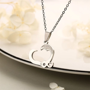Detail of silver heart necklace with 'I love you' engraving and small diamond accent