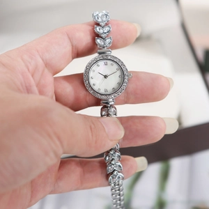Detailed close-up of mermaid luxury watch with shimmering mother-of-pearl dial and crystals