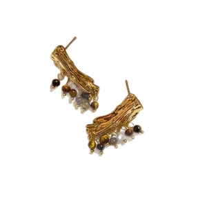 Vintage golden wavy stud earrings with brown resin beads on white background