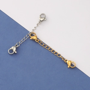 Close-up of gold and silver stainless steel extender chains with dual lobster clasps