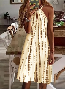 Détail du décolleté licou sur une robe d'été beige avec des rayures tie-dye marron