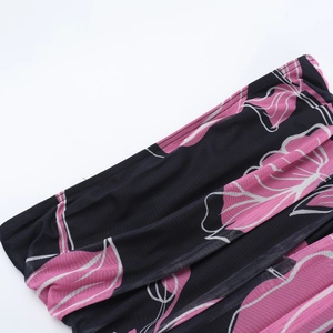 Detailed close-up of pink and black floral mesh fabric with refined stitching texture