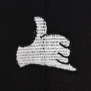 Close-up of white hand gesture embroidery on black outdoor baseball cap fabric