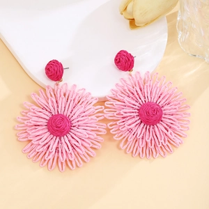 Pink handmade raffia flower earrings with layered petals for summer vacation style