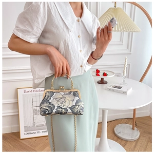 Exquisite floral embroidery and gold metal frame on a retro-style Chinese evening bag