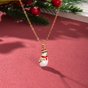 Macro view of Christmas snowman pendant with red scarf on a golden O-chain necklace