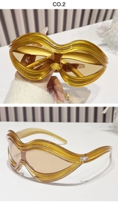 Detail of amber oversized Y2K sunglasses with unique wavy frames and resin texture