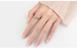 Detail of an adjustable silver spinner ring with sparkling zircon inlays on a finger