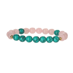 Macro view of pink quartz and turquoise beaded bracelet with gold accent spacers