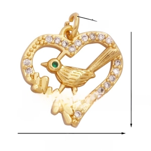 Detailed view of heart-shaped gold bird pendant with white zircons and green eye