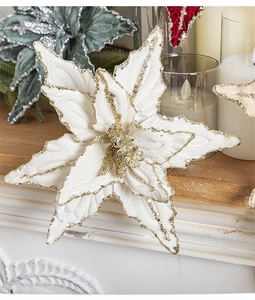 Close-up of artificial poinsettia flowers with glitter edges on a wooden table