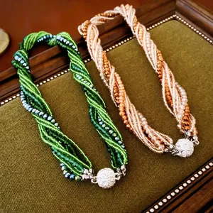 Multi-strand crystal bead necklace with sparkling rhinestone magnetic sphere clasp