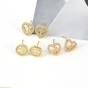 Three pairs of vintage gold cross earrings with heart shape and zircon inlay on white base