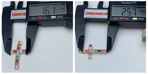 Measurements of 18k gold cross pendant with multi-color stones showing size 16x25 mm