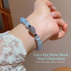 Elegant beaded bracelet featuring blue cat eye stone, black agate, and grey chalcedony on wrist