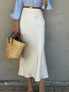 Elegant white satin bodycon maxi skirt for women styled with a belt and blue shirt