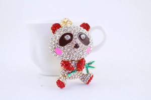 Macro shot of rhinestone-studded panda keychain with green enamel bamboo details