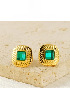 Detail of square vintage gold earrings featuring green zircon and 18K plated texture