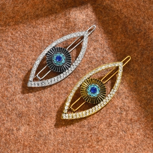 Sparkling rhinestone evil eye hair clips in gold and silver finish with blue accents