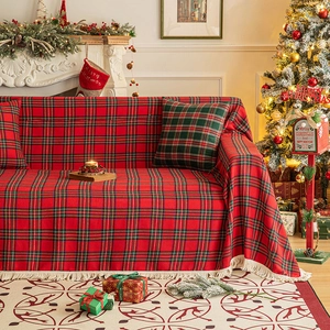 Christmas red and green plaid sofa throw blanket with white fringe in a festive living room