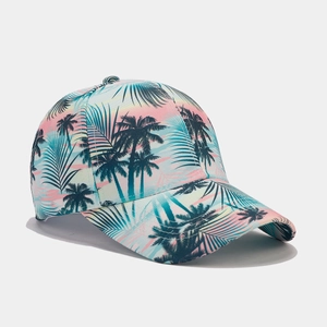 Detail of tropical palm tree prints on pink and blue gradient baseball cap surface