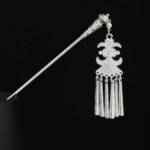 Detailed view of silver Hmong hair pin with intricate filigree pendants and bells