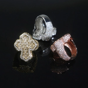 Macro shot of hip hop cross rings in gold, silver and rose gold with zircon inlay