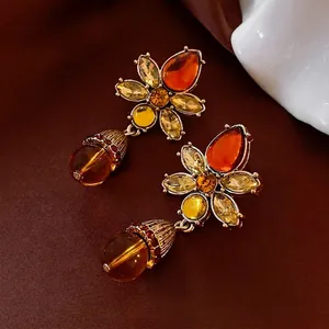 Vintage floral drop earrings with amber crystals and red teardrop beads in antique gold