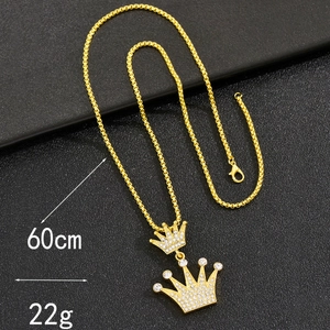 Detailed view of gold crown pendant with rhinestones on 60cm box chain, 22g weight