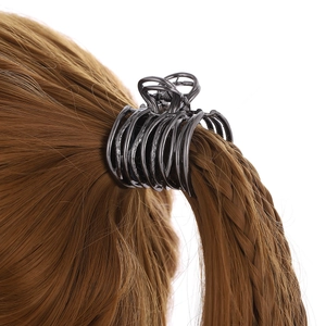 Sleek dark gray metal hair claw clip for high ponytail styling on brunette hair