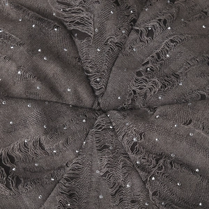 Detail of coffee brown knit beanie featuring distressed holes and sparkling rhinestones