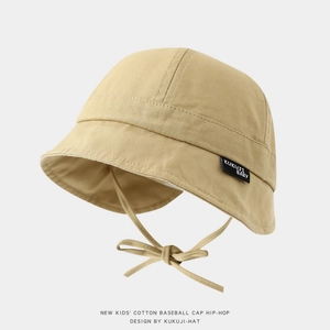 Detail of khaki cotton baby sun hat showing fabric texture and ear-flap ties with bow