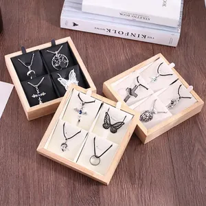 Bamboo jewelry display tray with 4 slots featuring black and beige fabric inserts