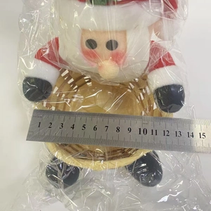 Detail view of a 12cm bamboo Christmas candy basket with a plush Santa Claus doll