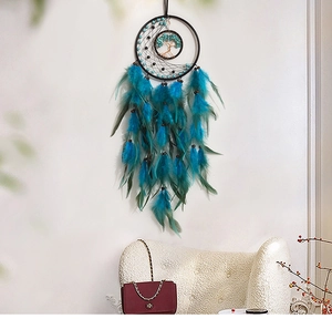 Detail of tree of life dreamcatcher with turquoise feathers and brown beads decor