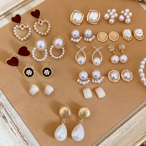Elegant gold-tone earring set featuring pearls, rhinestones and heart-shaped enamel studs