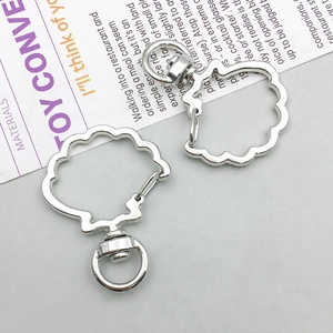 Detail of two silver shell-shaped lobster clasps for DIY jewelry and keychains