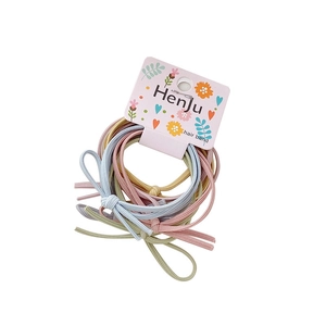 Pastel bow elastic hair bands in pink, blue, yellow, and green on white background